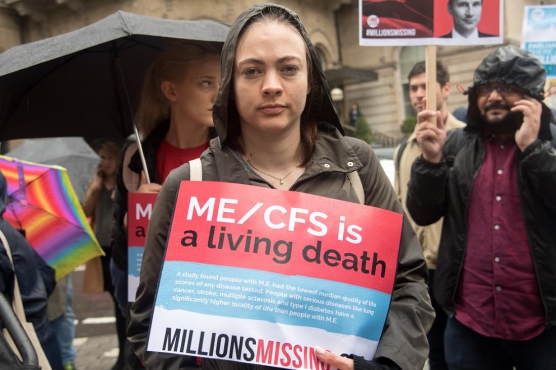 A woman holds a sign for patients suffering from ME during “Millions Missing” rally in London. Those with the illness are known as the “missing millions”, as they have had to drop out of everyday life. Photo: Alamy