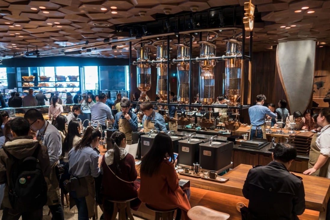 Visitors wait for their coffee at the Starbucks Reserve Roastery store in Shanghai on December 6, 2017. Starbucks opened its largest cafe in the world in Shanghai on December 6 as the US-based company bets big on the burgeoning coffee culture of a country traditionally known for tea drinking. Photo: Agence France-Presse