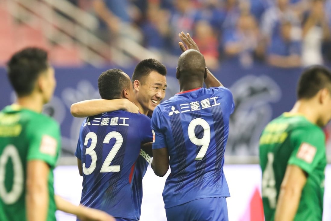 Shanghai Shenhua players celebrate after scoring against Beijing Guoan during the China derby. Photo: Xinhua
