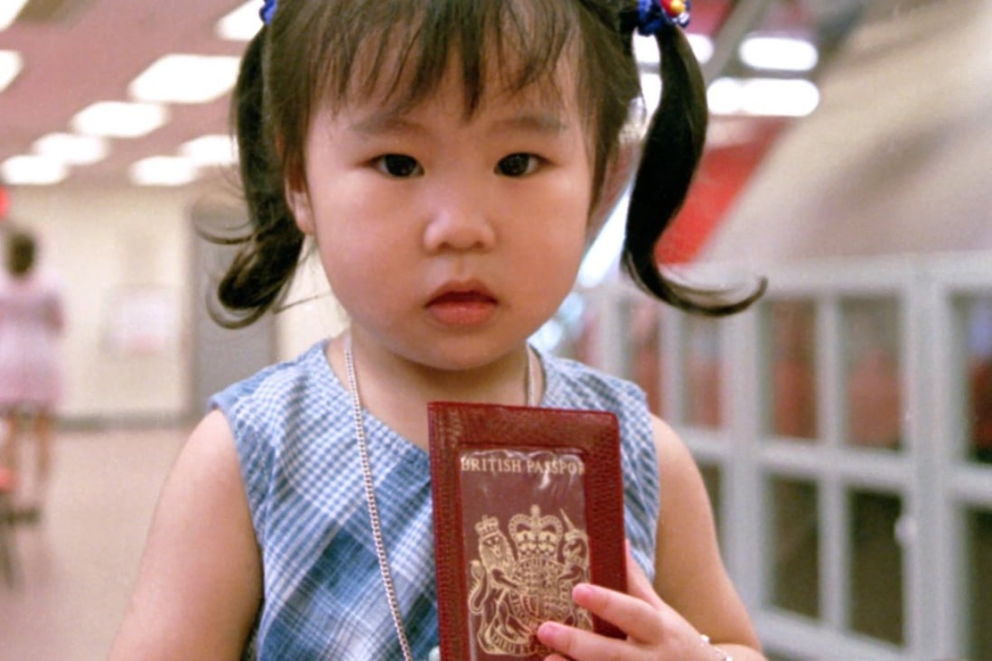 A two-year-old girl clutches her passport at the Immigration Department in 1995. Parents were signing their children up in droves to obtain British National (Overseas) passports ahead of the city’s return to Chinese rule in 1997. Photo: SCMP
