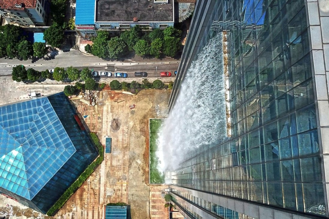 A property developer says the waterfall down its luxury hotel development in southern China is the biggest in the world. Photo: AFP/China OUT