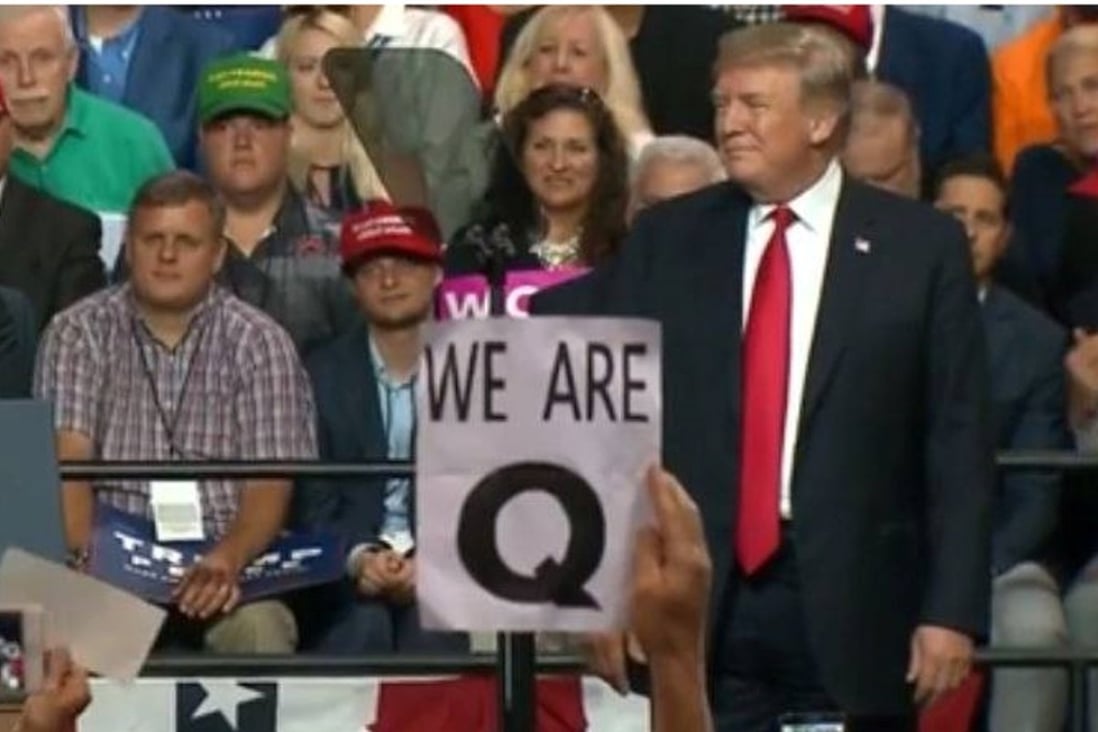 A rally participant holds up a “We are Q” poster at Donald Trump's recent rally in Tampa, Florida. Photo: Fox News