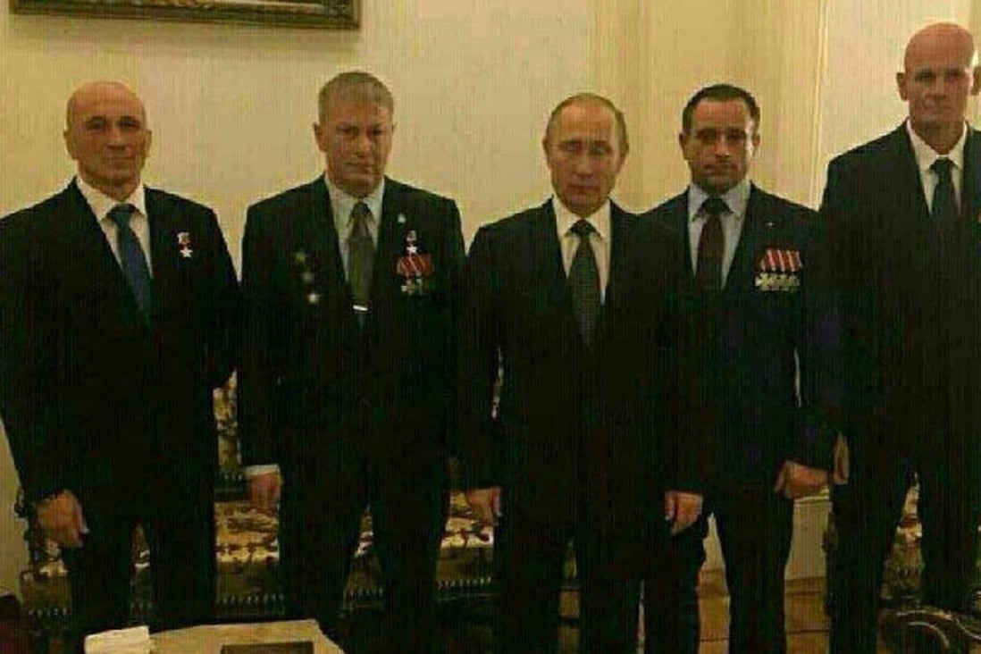 Russian President Vladimir Putin (centre) with supposed members of the Wagner Group of mercenaries, including founder Dmitry Utkin (far right). Photo: Twitter