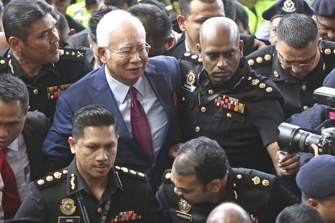 Former Malaysian prime minister Najib Razak arrives at a courthouse in Kuala Lumpur to face charges stemming from a corruption investigation. Photo: AP