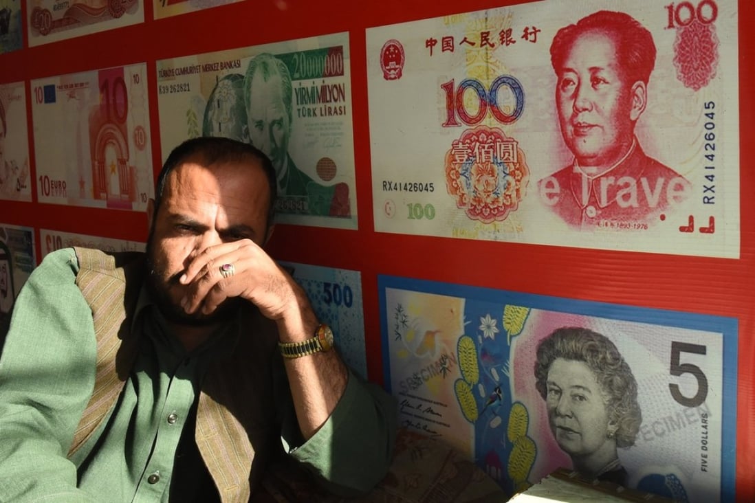 A currency dealer in Quetta, Pakistan. Photo: AFP