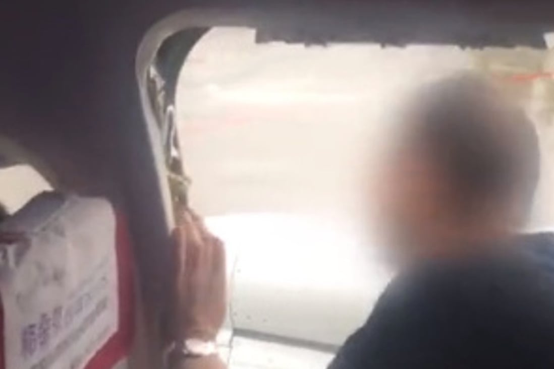 Passengers filmed the man as he opened the escape hatch. Photo: Weibo