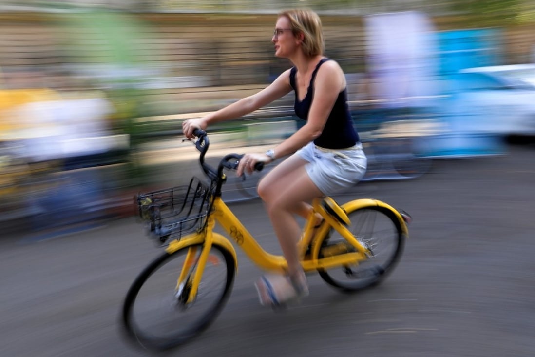 A woman rides an Ofo bike in Paris. Photo: Reuters