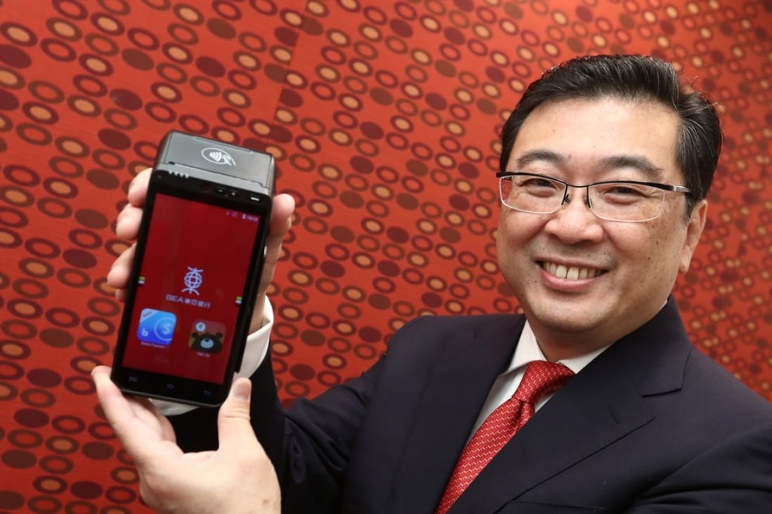 Vincent Hui, general manager and head of personal banking division at Bank of East Asia, demonstrates the i-Payment hub, the lender’s new offering in the mobile payments market. Photo: Nora Tam