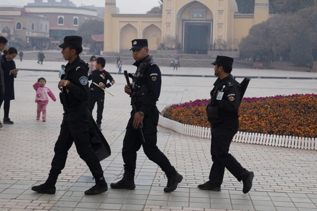 Uygur security personnel patrol near the Id Kah Mosque in Kashgar in Xinjiang region. Photo: AP
