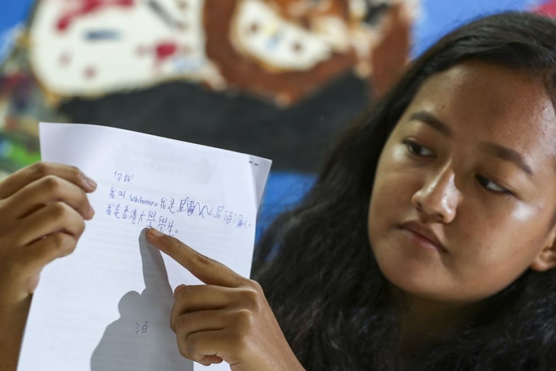 Suskihanna Gurung, 21, displaying her Chinese handwriting. Gurung will take part in a UN committee meeting addressing racial discrimination in Hong Kong. Photo: Nora Tam