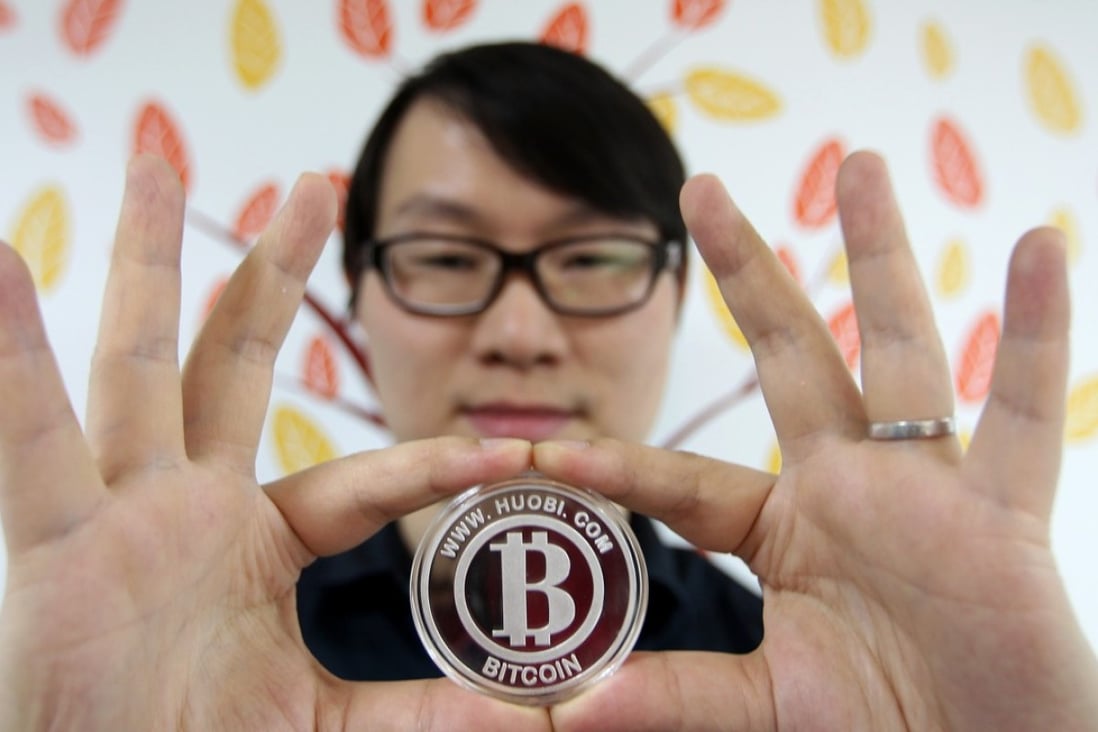 Leon Li Lin, founder and chief executive of cryptocurrency exchange operator Huobi Group, holds up a bitcoin logo. His Singapore-based company is supporting the establishment of digital currency exchanges in five new markets. Photo: Simon Song