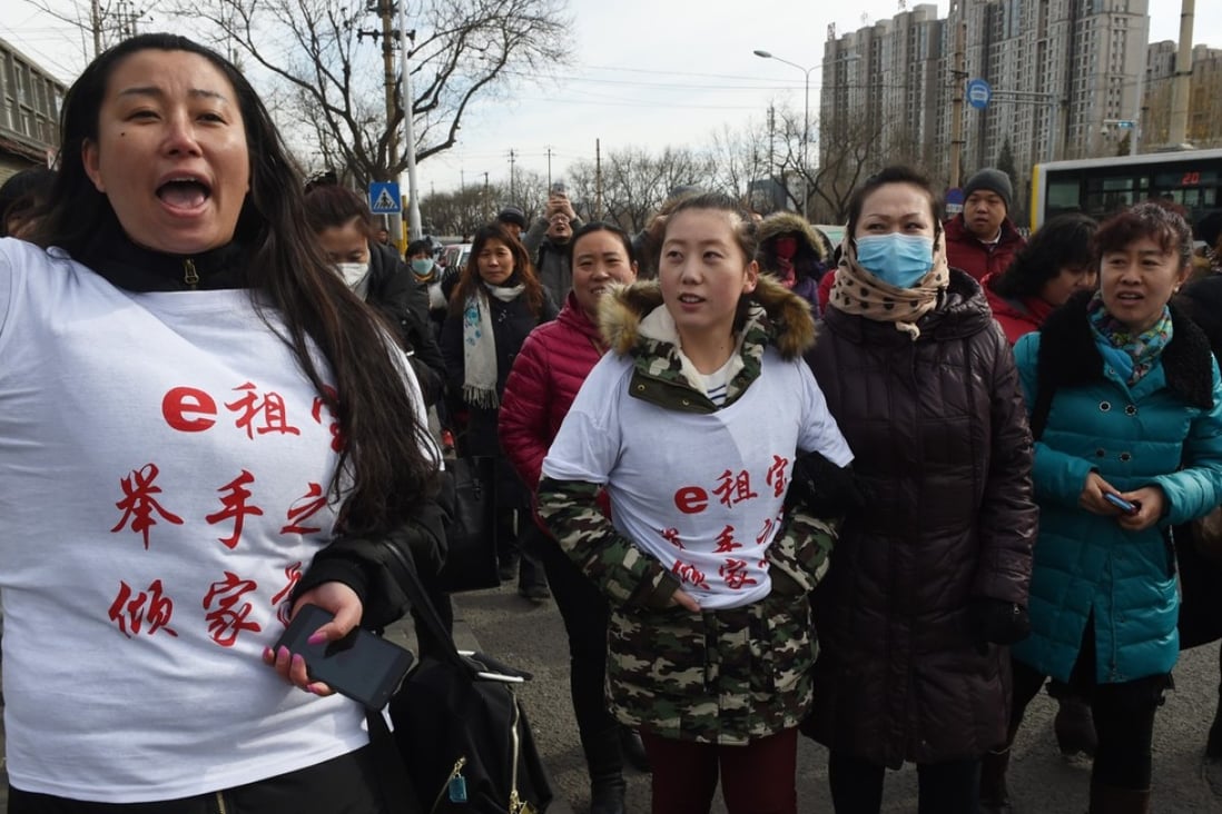 Aggrieved investors of online peer-to-peer lender Ezubao during a protest in Beijing on February 4, 2016. As many as 21 people were arrested on charges of defrauding 900,000 people of more than 50 billion yuan (US$7.6 billion), after Ezubao turned out to be a giant Ponzi scheme. Photo AFP