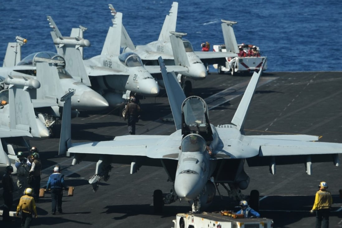 Sailors preapre FA-18 Hornet fighter jets for take off during a routine training aboard the US aircraft carrier Theodore Roosevelt in the South China Sea on April 10. The carrier was on its way to the Philippines at the time. Photo: AFP