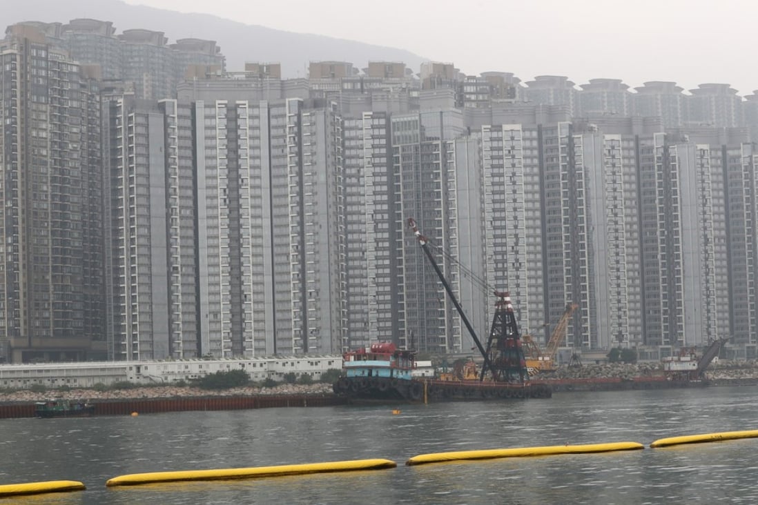 Reclamation work in Tung Chung. The yellow floats form a net preventing sand and rocks from spreading, though enviromental groups doubt its reliability. Photo: Nora Tam