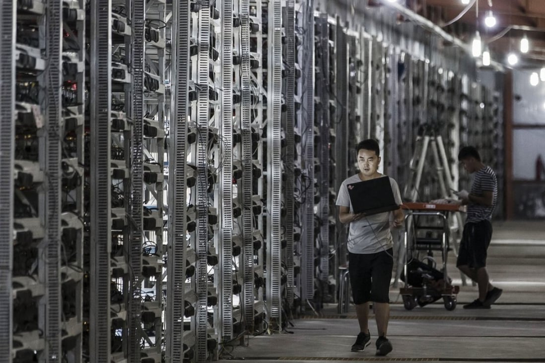 Technicians inspect bitcoin mining machines at a facility operated by Bitmain Technologies in Ordos, Inner Mongolia. Bitmain, which is also one of the biggest operators of cryptocurrency mining collectives, is planning a Hong Kong initial public offering that could raise as much as US$3 billion. Photo: Bloomberg