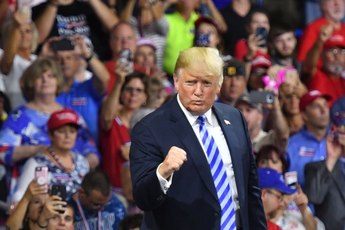 US President Donald Trump salutes his supporters after speaking at a rally in Charleston, West Virginia, on August 21. Trump remains defiant in the face of his former personal lawyer pleading guilty to violating campaign laws. Photo: AFP