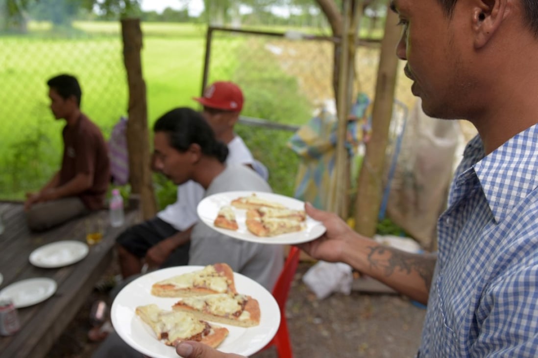 A little slice of America is served to refugees who were deported to Cambodia from the United States. Photo: AFP