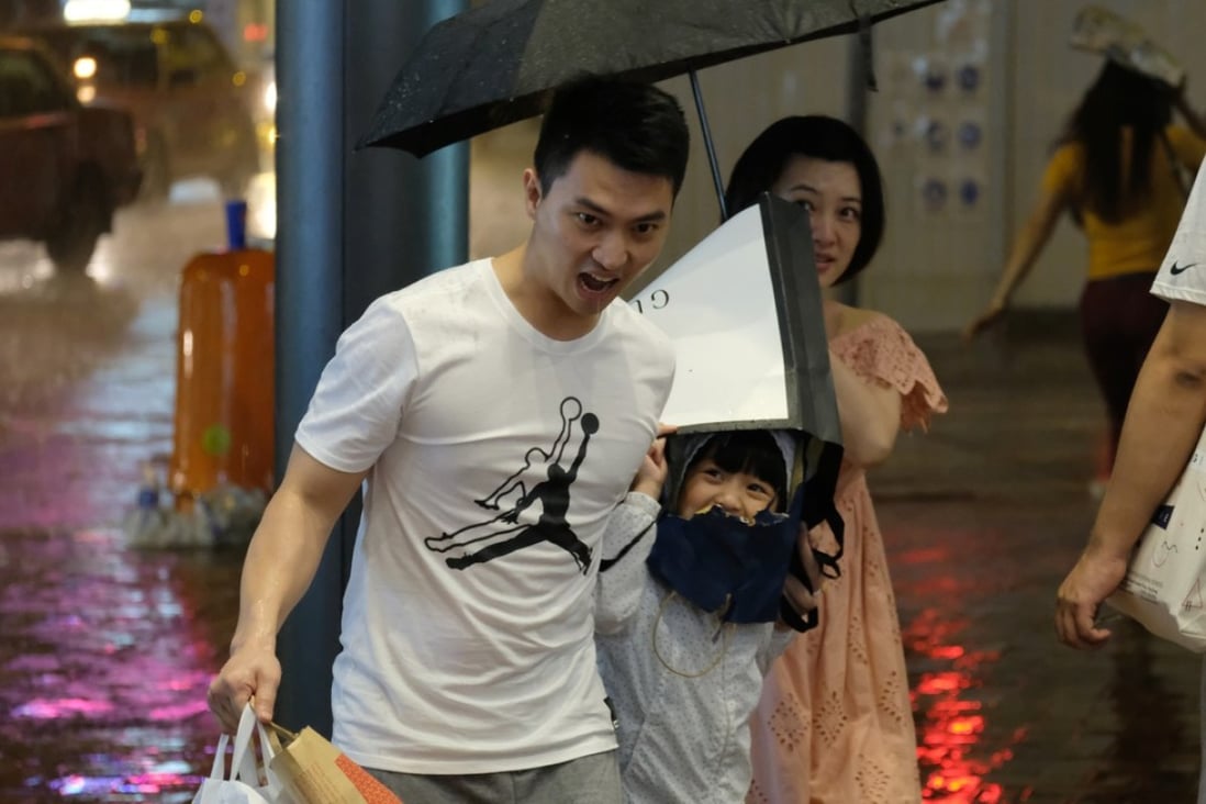 Residents walking through heavy rain in Causeway Bay. Photo: Fung Chang