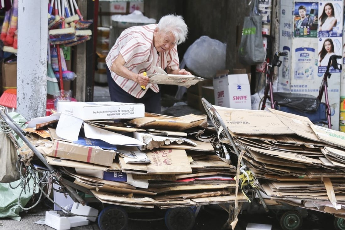 An elderly woman collects cardboard in North Point. According to a recent survey, these “cardboard grannies” earn just HK$716 per month, on average. Photo: Dickson Lee