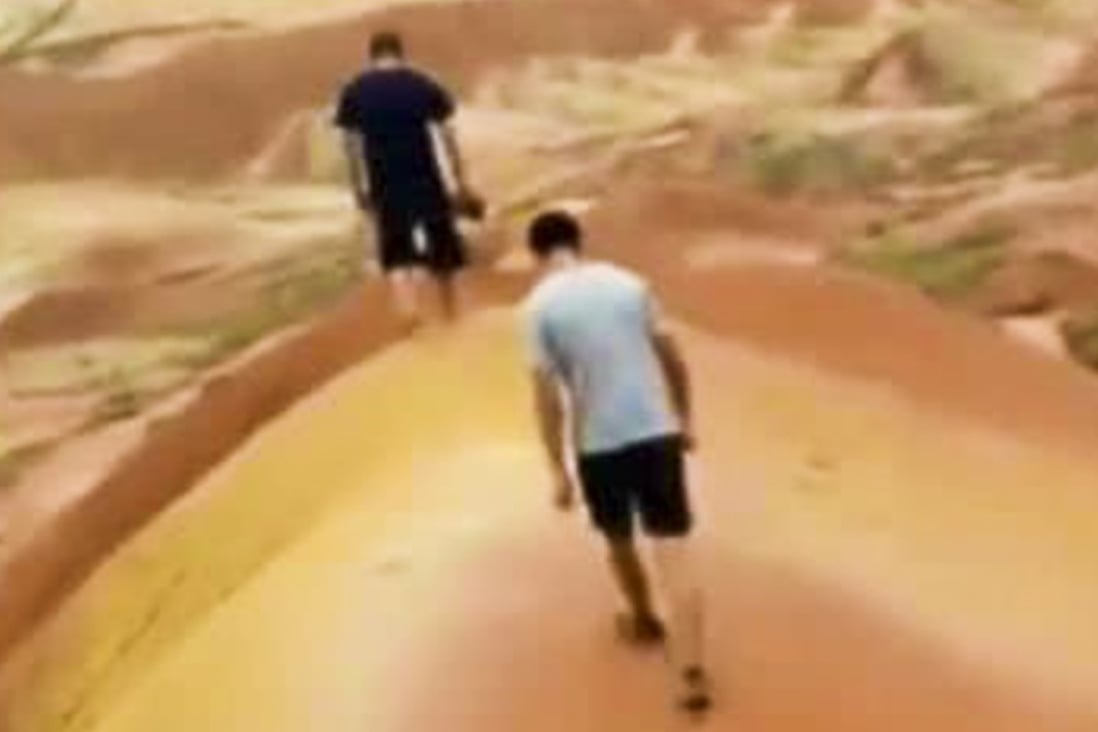 Two of the young Chinese tourists who broke into a Danxia national geopark in Zhangye, Gansu province and filmed themselves damaging the ancient landform. Photo: Weibo