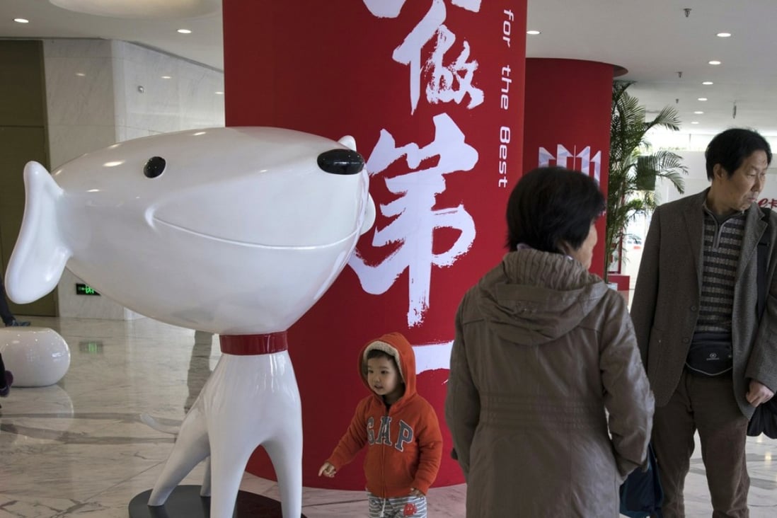 A child stands near the mascot for Chinese e-commerce giant JD.com at the headquarters in Beijing, China. Photo: AP