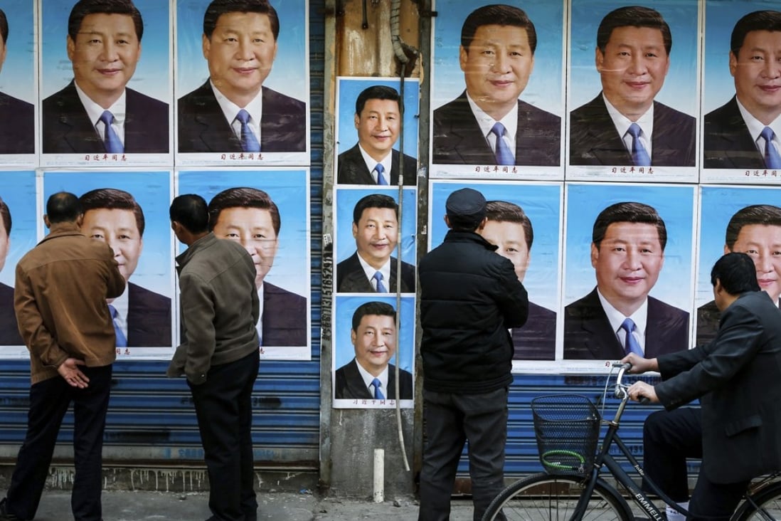 Posters of Chinese President Xi Jinping are plastered on a wall in Shanghai in March 2016. Photo: Chinatopix via AP