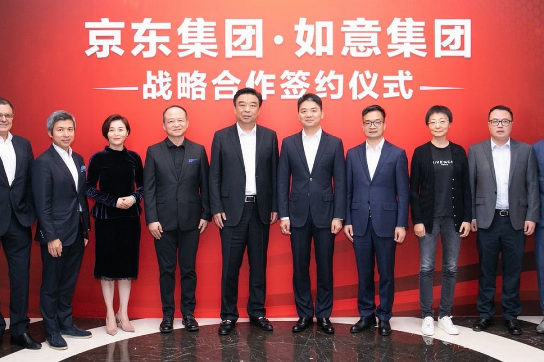 JD.com chief Richard Liu Qiangdong (fifth from right) at company's Beijing headquarters on Tuesday.