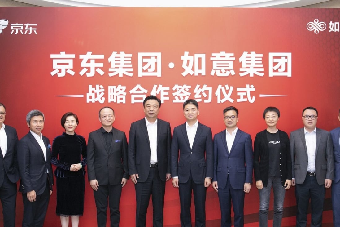 JD chief executive Richard Liu Qiangdong (fifth from the right) with Ruyi Group chairman Qiu Yafu to his right, and flanked by executives from both companies at the signing of a strategic partnership at JD's Beijing headquarters on Tuesday. Photo: Handout