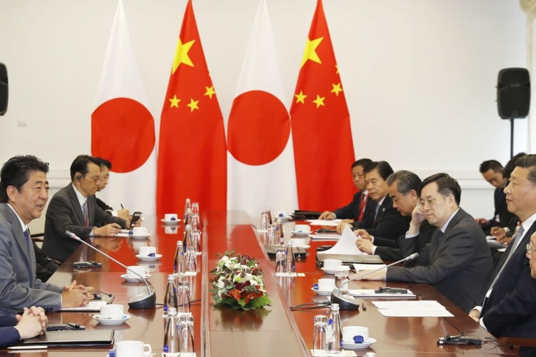 Japanese Prime Minister Shinzo Abe (second from left) and Chinese President Xi Jinping (second from right) hold talks in Vladivostok on Wednesday. Photo: Kyodo