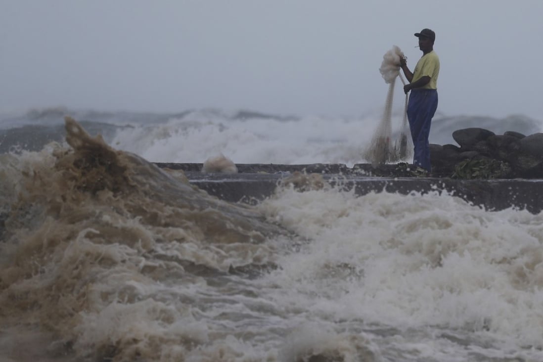 A Filipino fisherman near the shoreline in the town of Aparri, Cagayan province, which was set to take a battering from Mangkhut. Photo: EPA