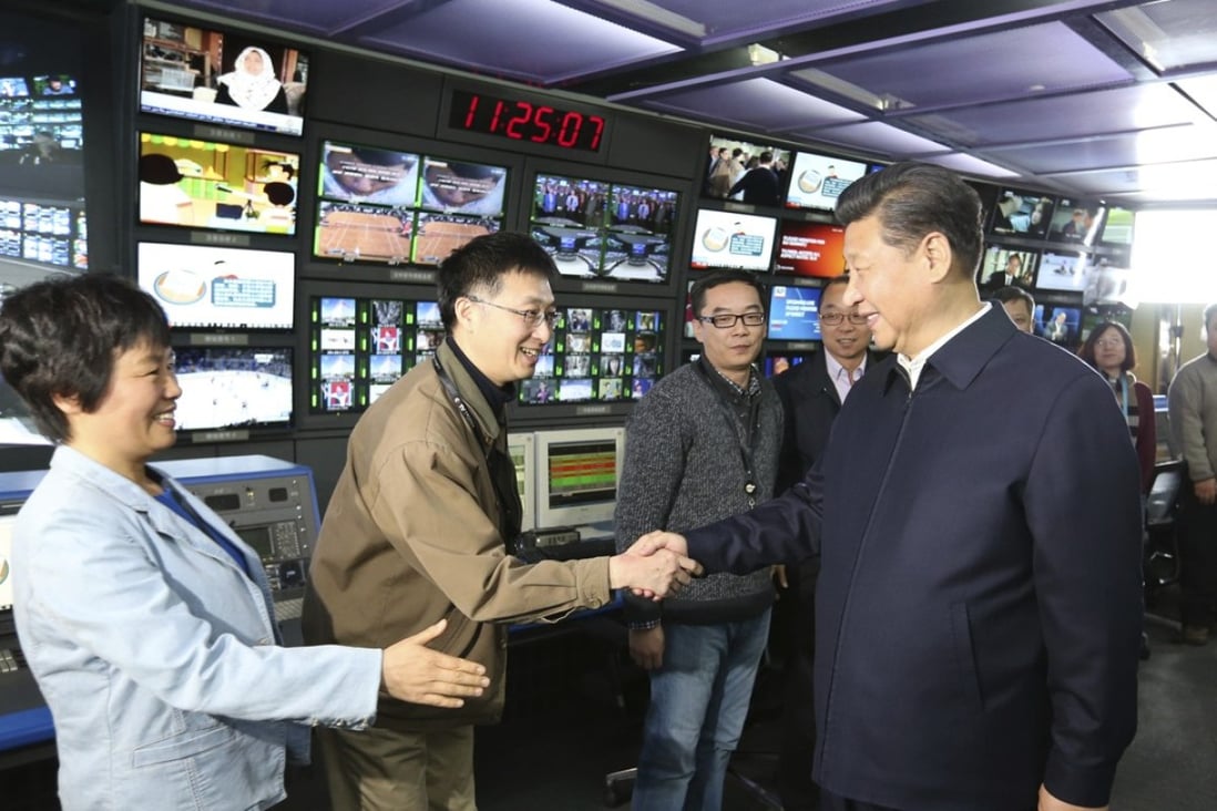 Chinese President Xi Jinping (right) shakes hands with staff members at China Central Television (CCTV) in Beijing. The US Department of Justice has ordered CGTN, CCTV’s international arm, to register with the government as a foreign agent. Photo: AP