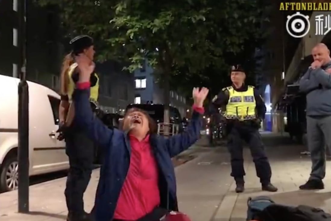 A Chinese man cries out after his family is evicted from a Swedish hostel by police just after midnight on September 2. Photo: Handout