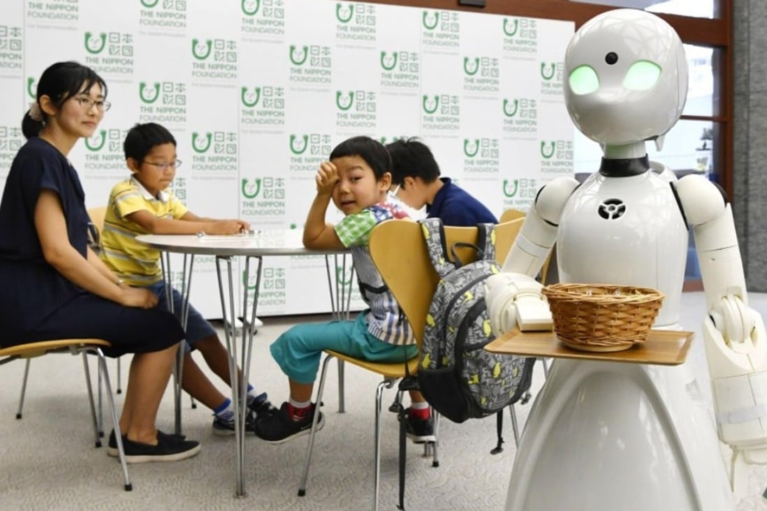 A cafe will open in Tokyo’s Akasaka district in November featuring robot waiters remotely controlled from home by people with severe physical disabilities. Photo: Kyodo