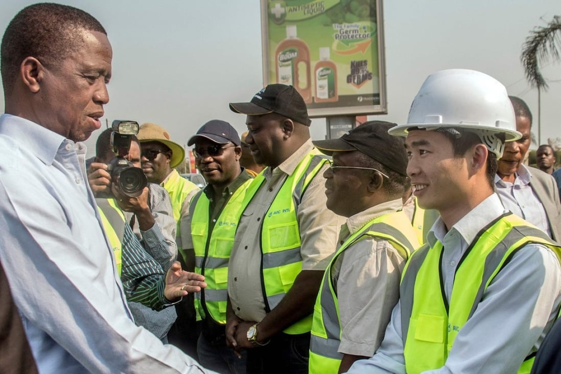 Zambian President Edgar Lungu (left) greets Chinese workers from Aviation Industry Corporation of China in Lusaka earlier this month. Photo: AFP