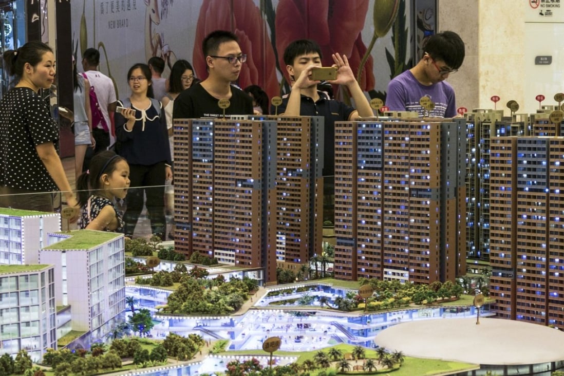 Chinese property investors viewing scale models of apartments in Shenzhen, Guangdong province. China’s housing ministry on Tuesday ordered six provinces, including Guangdong, to rethink their pre-sale system. Photo: Alamy