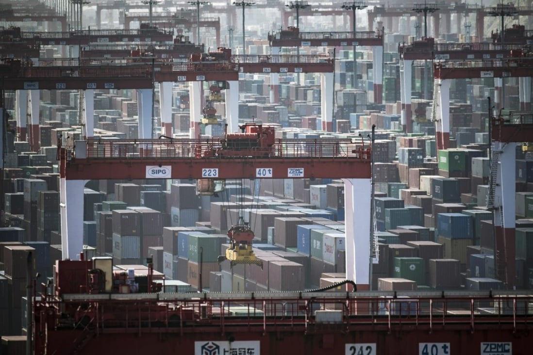 Containers stacked next to gantry cranes at the Yangshan Deep Water Port in Shanghai on Tuesday, July 10, 2018. Photo: Qilai Shen/Bloomberg