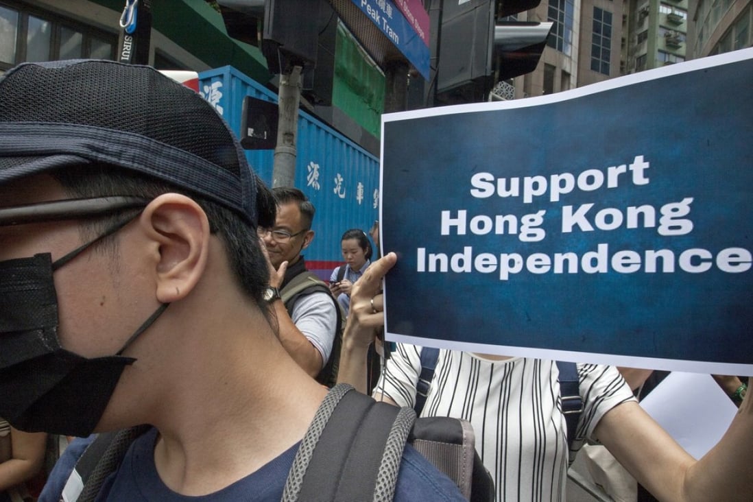 Pro-independence supporters gather near the Hong Kong Foreign Correspondents’ Club on August 14 in support of National Party leader Andy Chan, who gave a speech at the venue. Photo: EPA