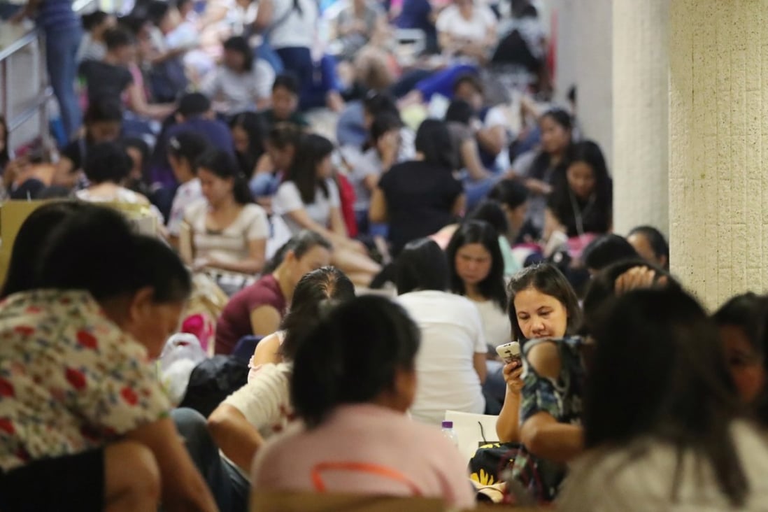 Domestic workers gather in Central on a public holiday. Photo: Edward Wong