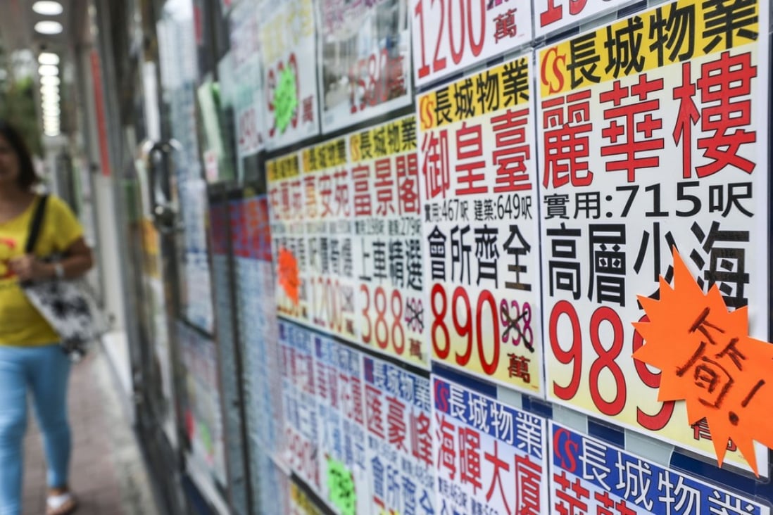 Property agents in Quarry Bay display flat prices on September 28. Photo: Edward Wong