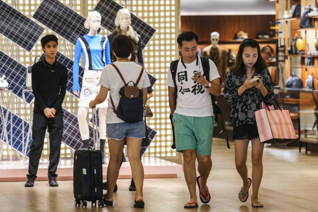 Shoppers exit Louis Vuitton at Times Square in Causeway Bay, Hong Kong. Many consumers choose to make their purchases while travelling overseas. Photo: Dickson Lee