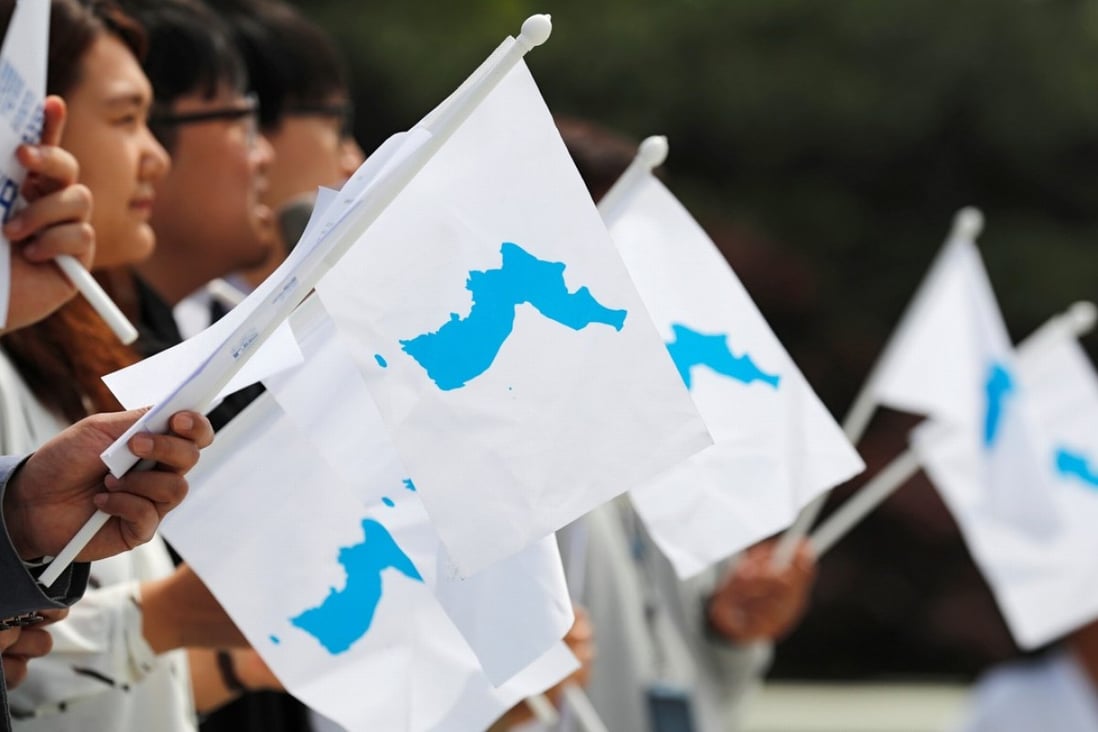 Students hold Korean unification flags ahead of the first of three summits so far this year between North and South, in Seoul in April. Photo: Reuters