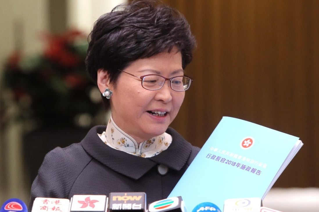 Chief Executive Carrie Lam holds a copy of her upcoming policy address. Photo: Handout