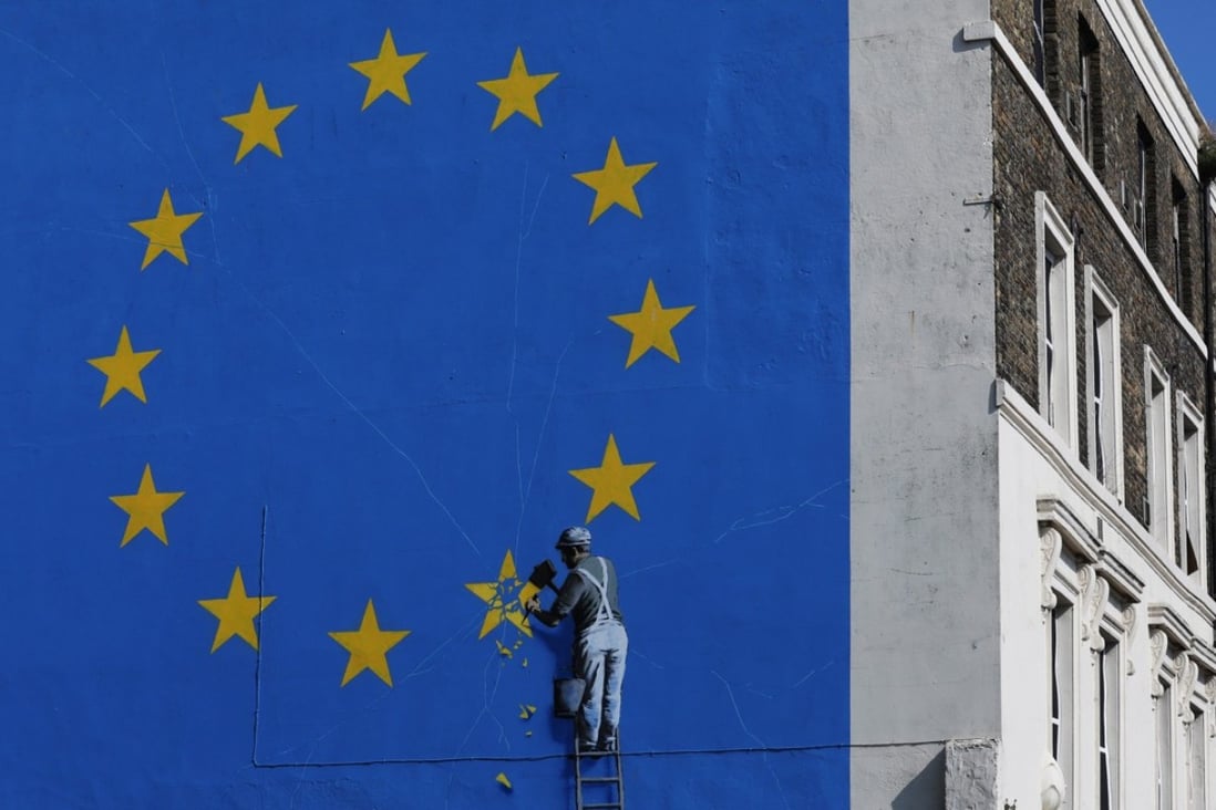 In a mural on the side of a building in Dover, Britain, street artist Banksy depicts Brexit as a workman chipping away a star on a European Union flag. The Europeans are not letting Britain make an easy exit; it might encourage the beginning of the end of European federalism. Photo: Bloomberg
