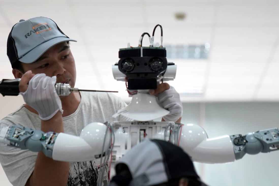 A worker puts the finishing touches to an iPal social robot, designed by AvatarMind, at an assembly plant in Suzhou, Jiangsu province, China, on July 4. Robotics is one of the focus areas under the Made in China 2025 plan. Photo: Reuters