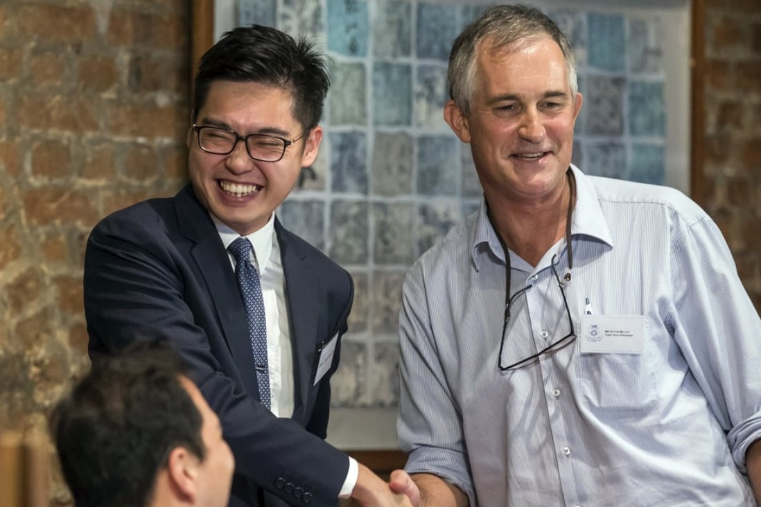 Andy Chan, founder of the Hong Kong National Party, shakes hands with Victor Mallet at the Foreign Correspondents’ Club in Hong Kong where Chan spoke in favour of the city’s independence from Chinese sovereignty, on August 14. Photo: AP
