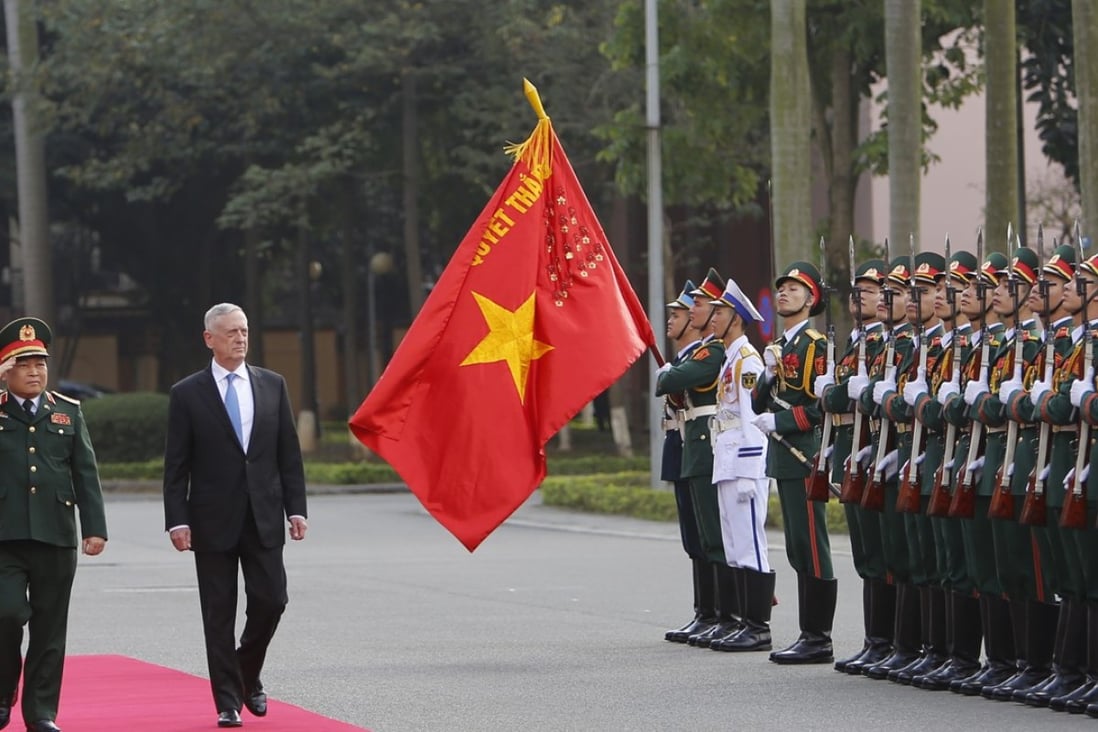 US Defence Secretary James Mattis and his Vietnamese counterpart Ngo Xuan Lich, left, review an honour guard in Hanoi during his first visit. Photo: AP