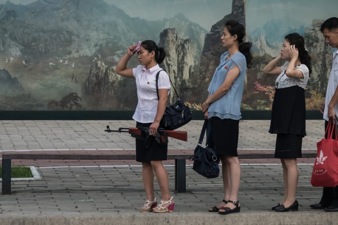 North Korean women wait at a bus stop in Pyongyang. Picture: AFP