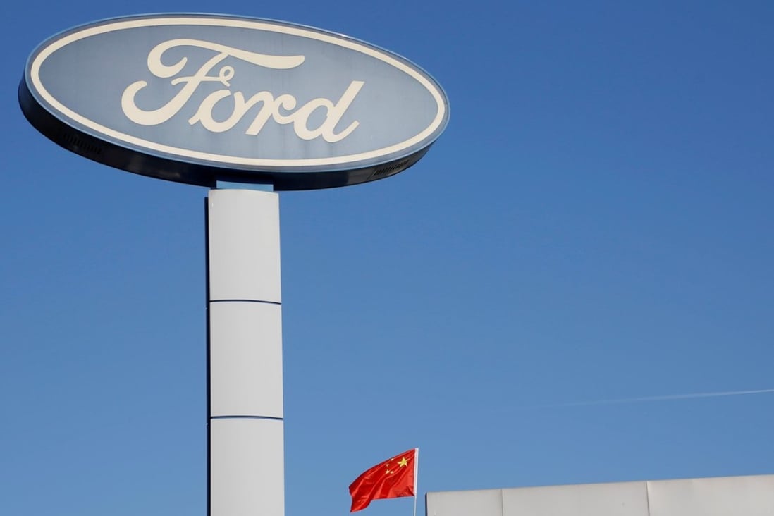 The Chinese national flag flies on the roof of a Ford car showroom in Beijing, China last week. Photo: Reuters