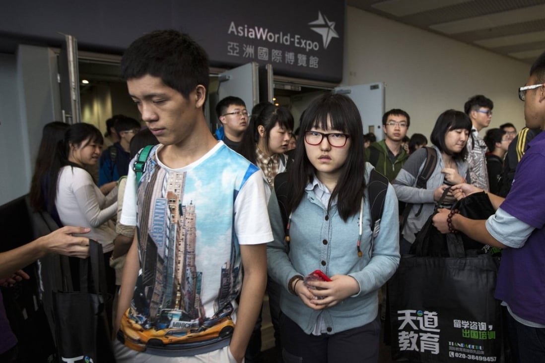 Students leave after sitting an SAT exam at AsiaWorld-Expo in Hong Kong. Photo: Reuters/Tyrone Siu