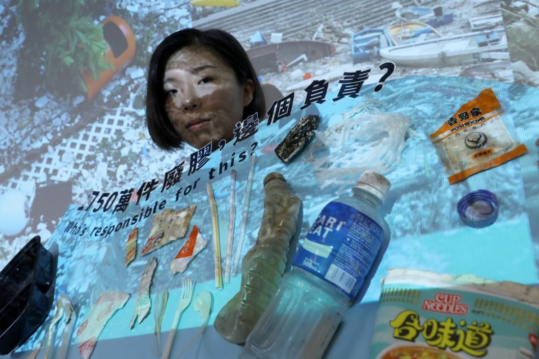 Greenpeace campaigner Chan Hall-sion showing some of the single-use plastic items found in different waterways in Hong Kong. Photo: Sam Tsang